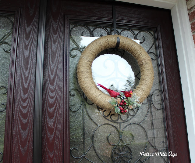 Christmas front door with twine wreath and red cardinals on it.