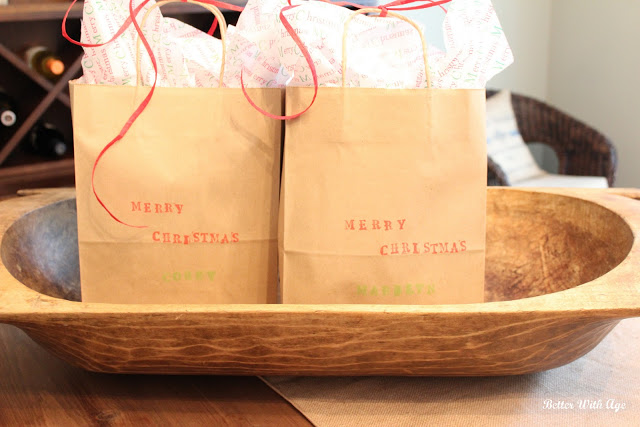 Kraft paper bags that say Merry Christmas with bows.