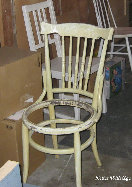 An old chair with the seat missing.