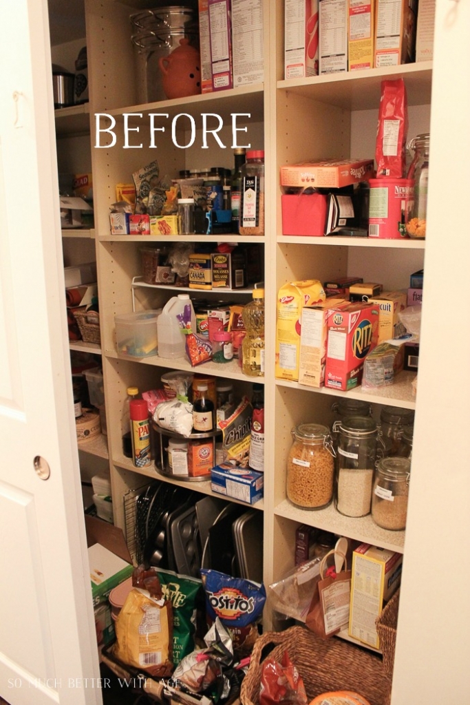 A before picture of the pantry with boxes of food items and baking sheets all cluttered together.