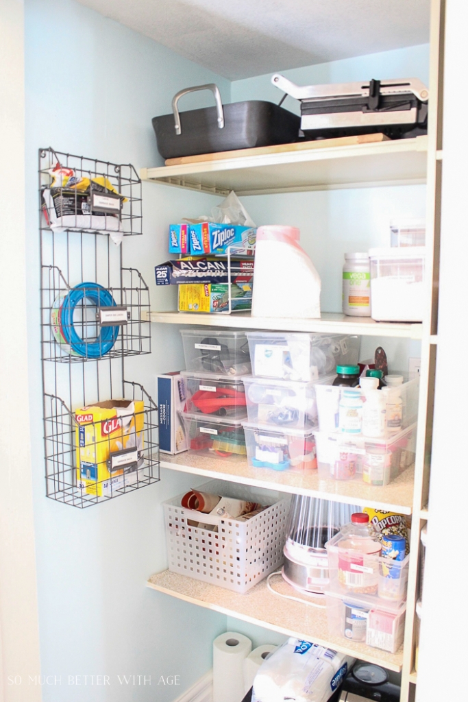 An organized pantry with items neatly stacked in bins.