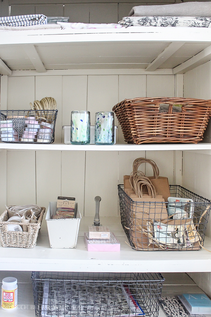 The baskets close up on the shelves in the cabinet.