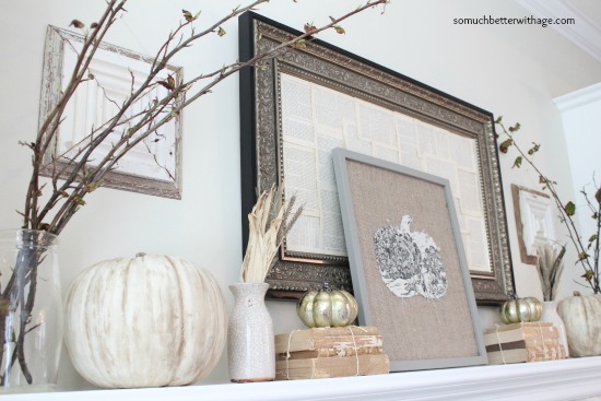 Fall branches and pumpkins on the white mantel.