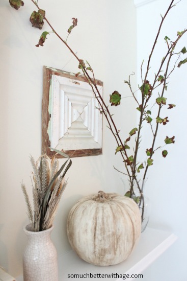 Fall leaves in a clear vase on the mantel.