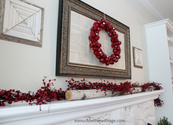 A red bell wreath hanging above the fireplace.
