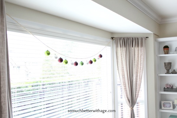 The string or ornaments up in the window of the living room.