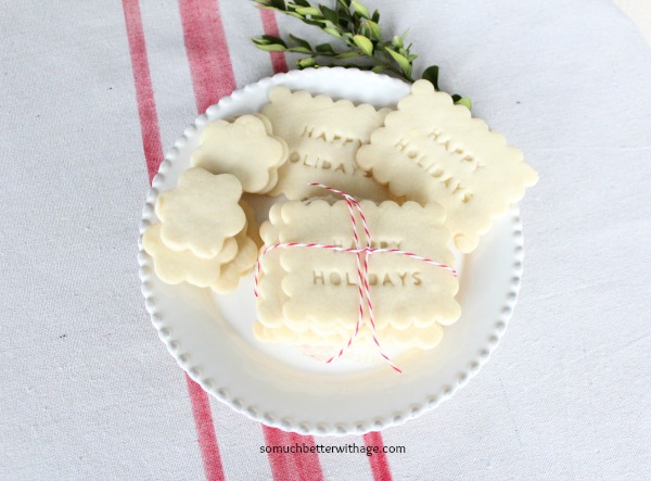 Shortbread on a white plate with a red and white twine bow.