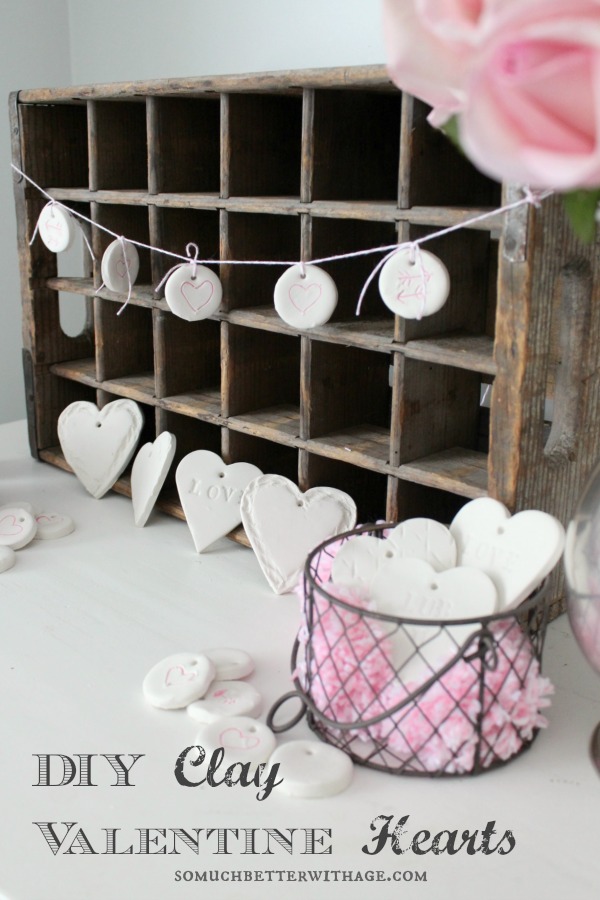 Clay hearts on string and sitting in wire basket.