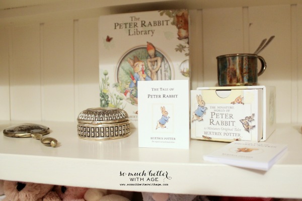 Silver baby mirror, cup and Peter Rabbit books.