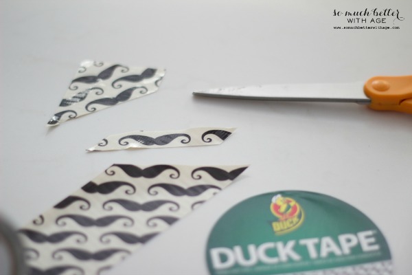 Mustache Duck tape with pieces of the mustache cut out.