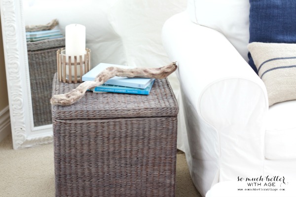 The painted wicker basket beside a white couch.