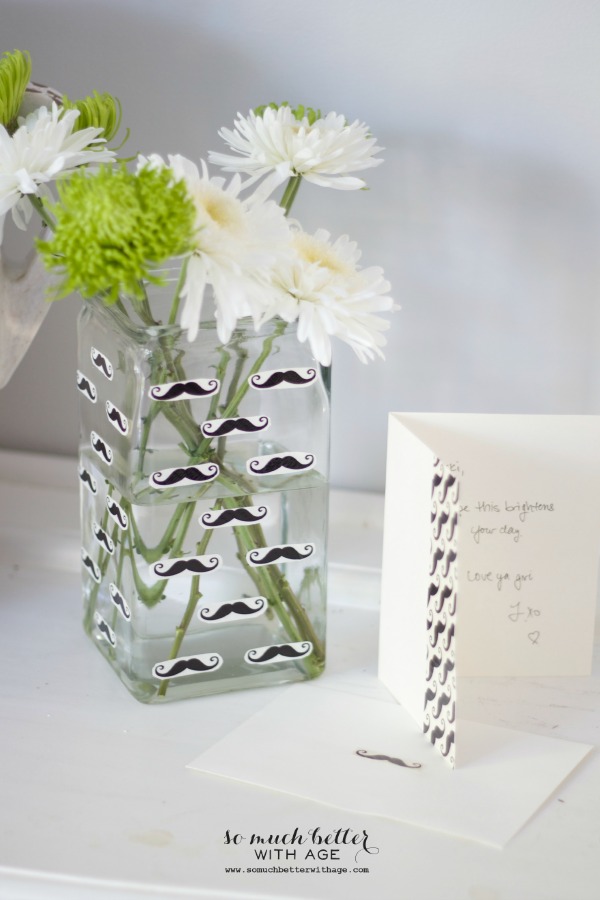 The card beside the vase.