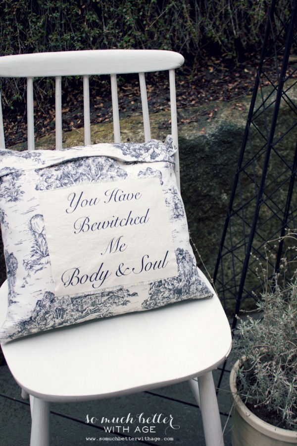 You have bewitched me body and soul pillow on a white chair.