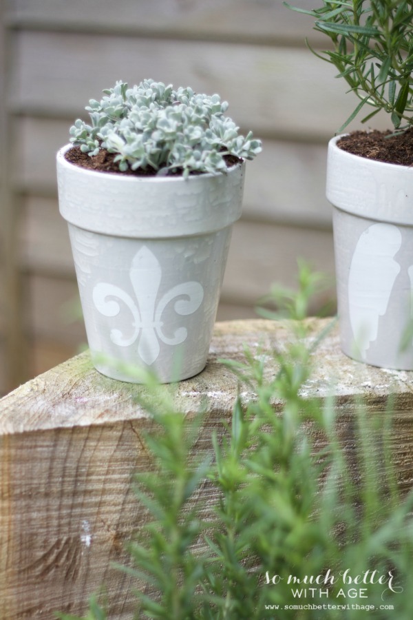 French glazed plant pots on the ledge.