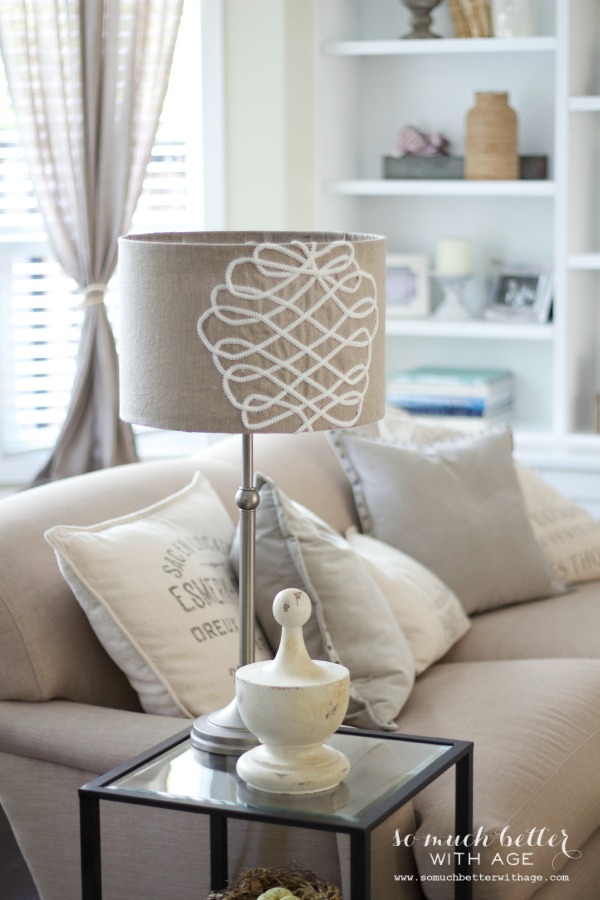 The DIY lampshade on a side table beside the couch.