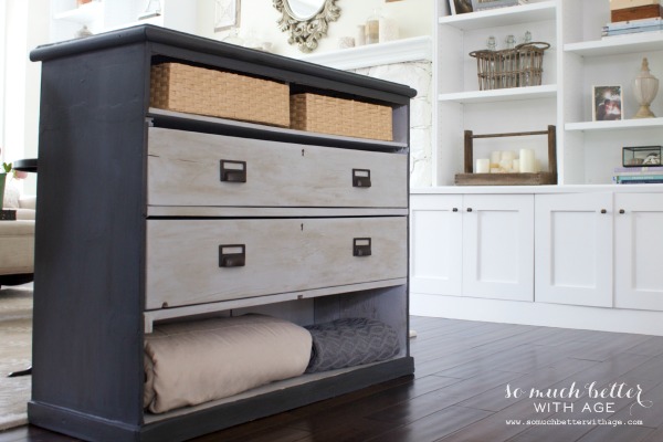 The painted dresser with blankets folded.