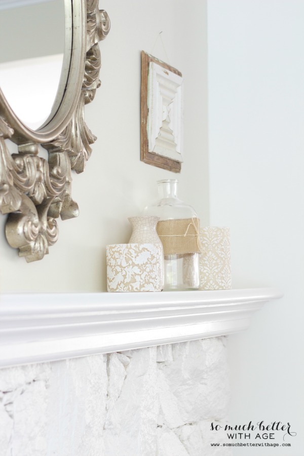 A mirror is above the fireplace mantel.