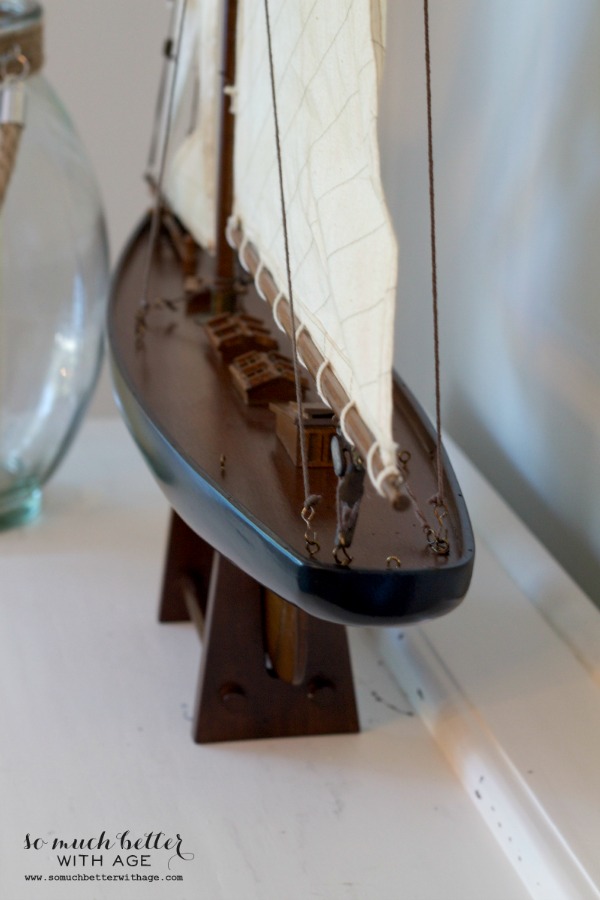 Wooden model sailboat with rigging.