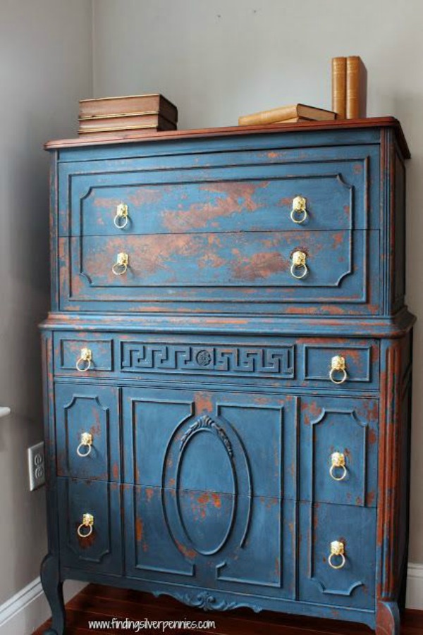 Distressed blue dresser with gold pulls.