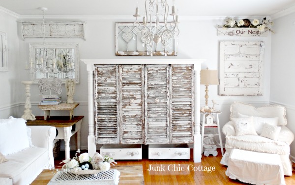 A living room with a white distressed cupboard.