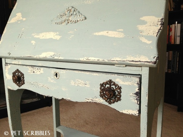 A soft teal distressed secretary desk with antique pulls.