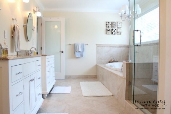 Large master bathroom with white cabinets and tub and shower.