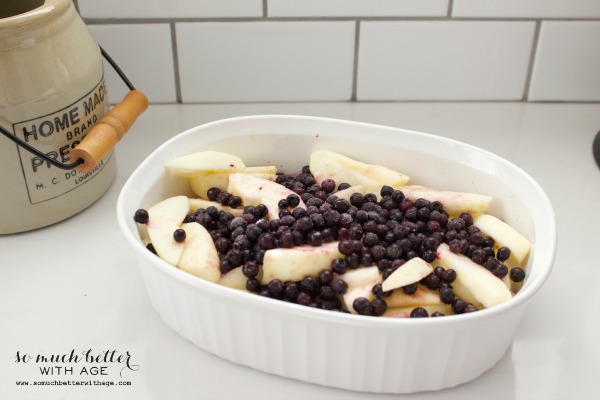 Blueberries and apples in a casserole dish. 