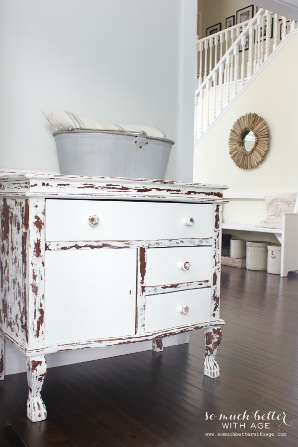 The chippy white drawers back inside the dresser.