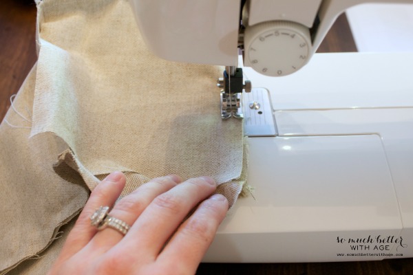 A sewing machine being used to sew the fabric together for the door stop.