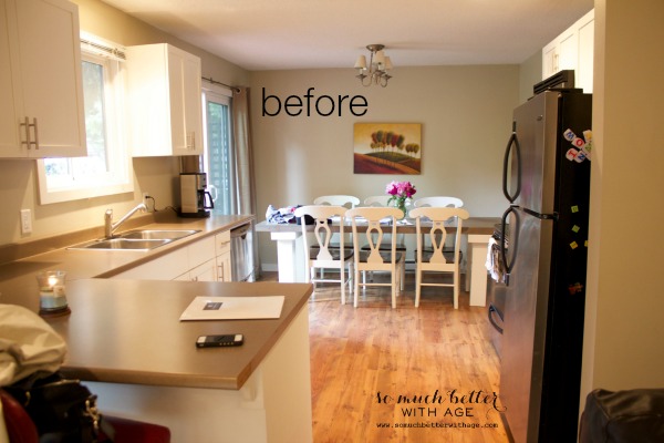 A before picture of the kitchen with an old 70's style light fixture above the table.