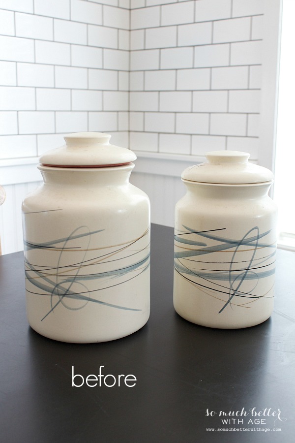 White crocks with graphic scribble lines on them sitting on a counter.