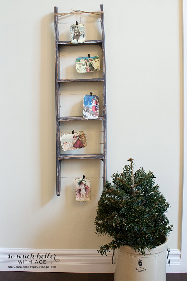 A ladder with Christmas pictures on it.