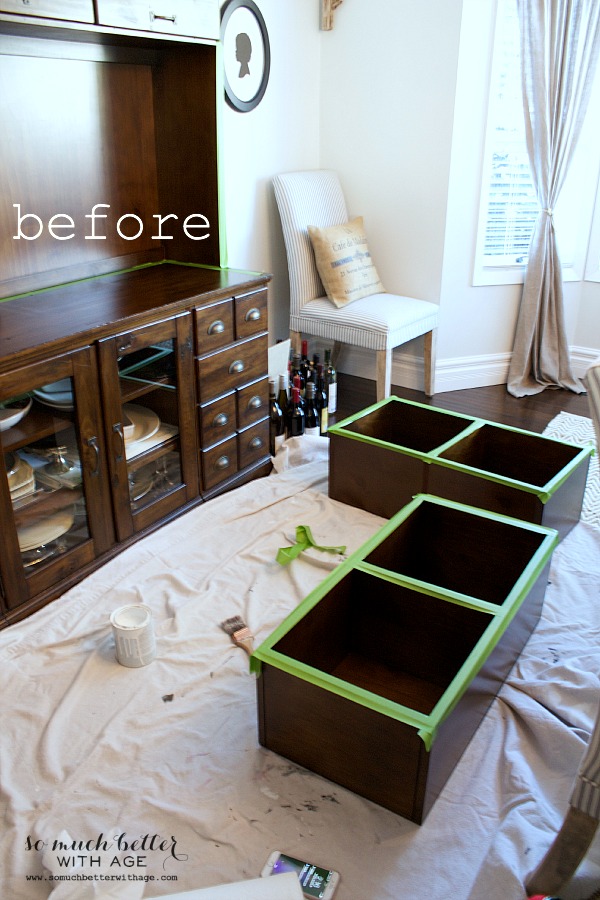 The drawers taken out of cabinet on drop sheet.