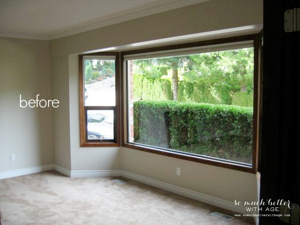 A completely empty dining room just carpet in it.