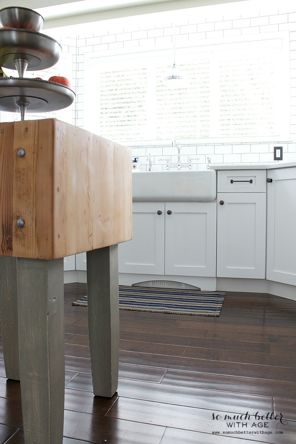 The wooden butcher block island in the kitchen.