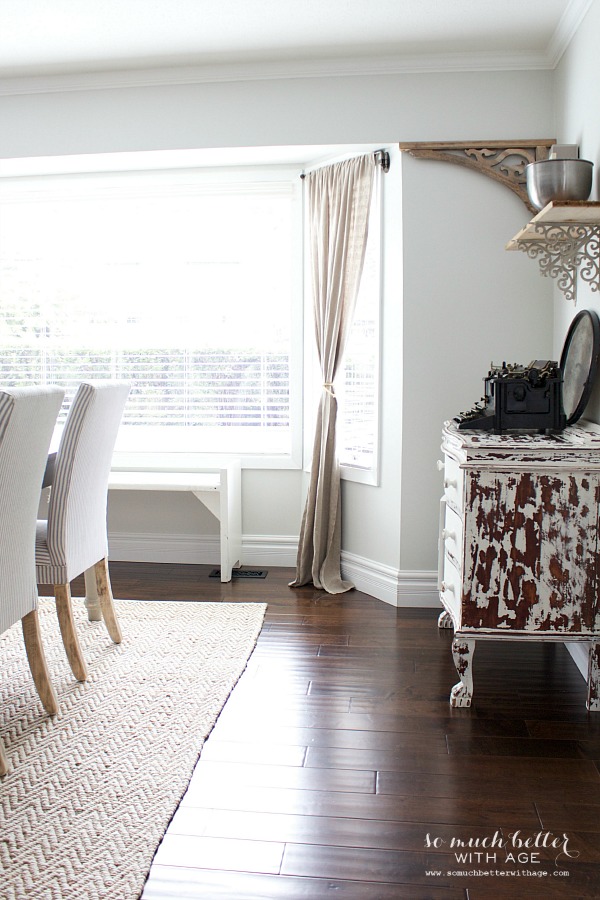 There is a cowhide dresser in the corner of the dining room.