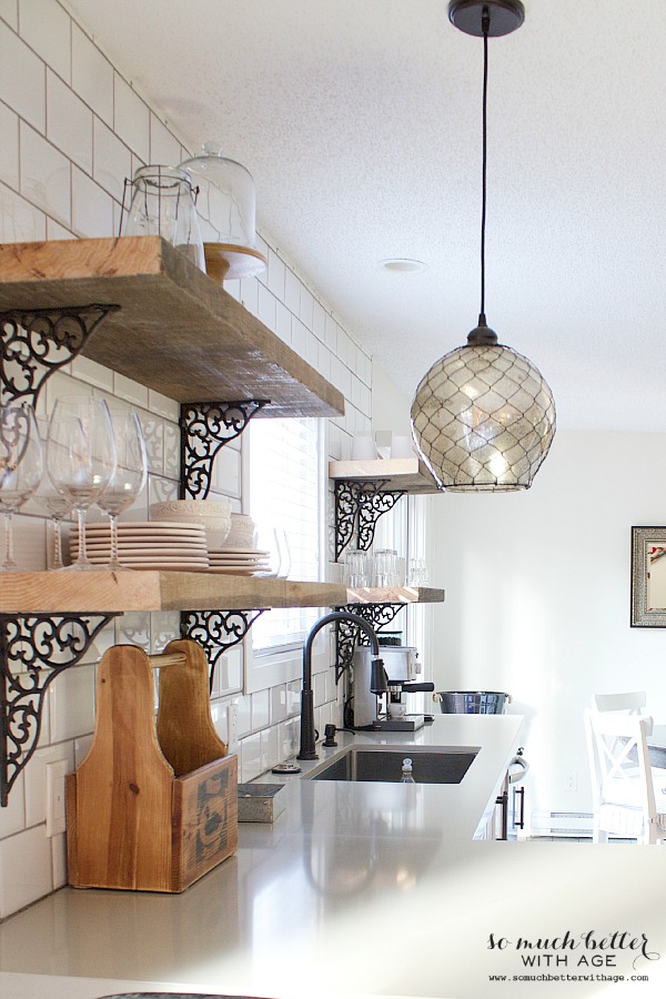 Light fixture in front of shelves.