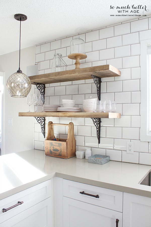 Cups and plates on the kitchen shelves.