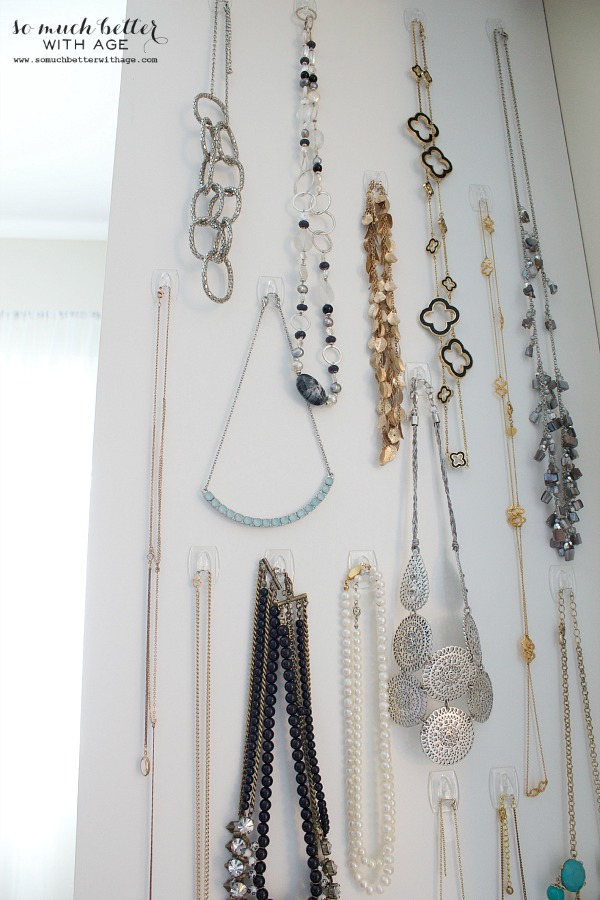 The bedroom necklace wall with multi coloured necklaces.