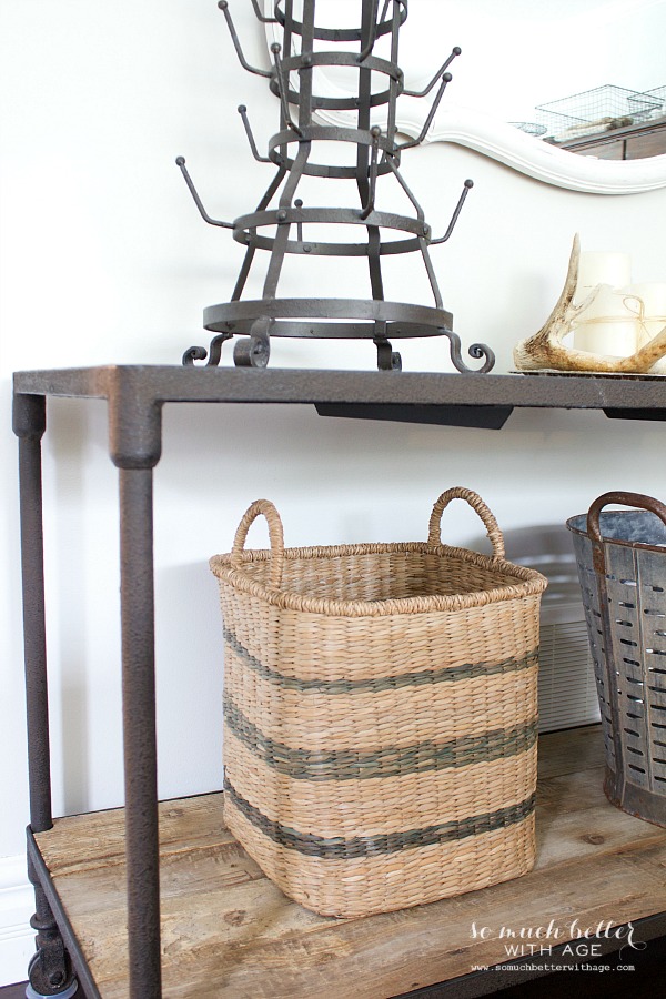 A wicker basket underneath the vintage side table.