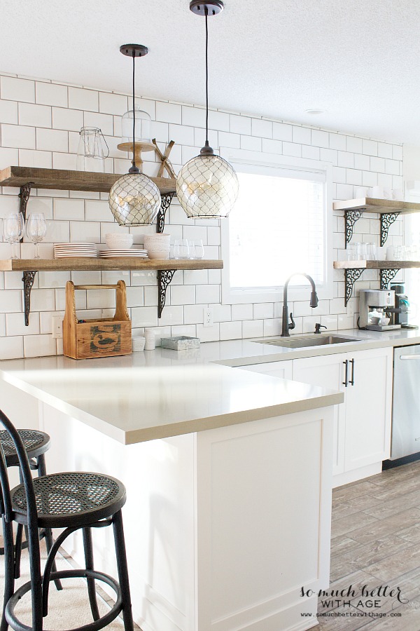 Black chairs beside kitchen counter.