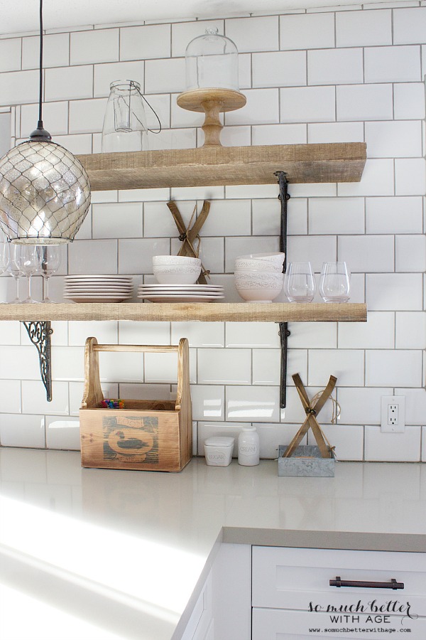 Farmhouse open shelves with a cake stand and dishes on it.