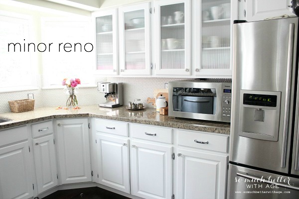 Stainless steel fridge and white cabinets.