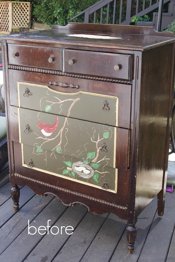 Dresser that is brown with a bird motif on front.