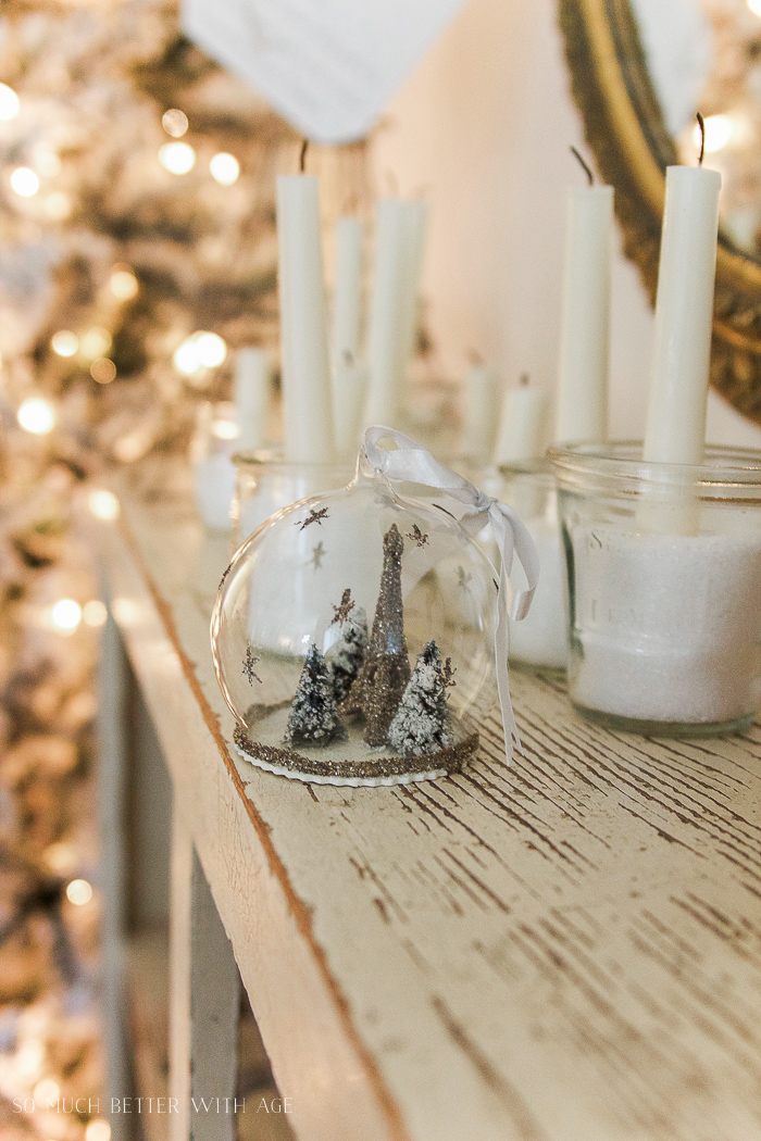  A snow globe Christmas ornament with an Eiffel Tower in it.