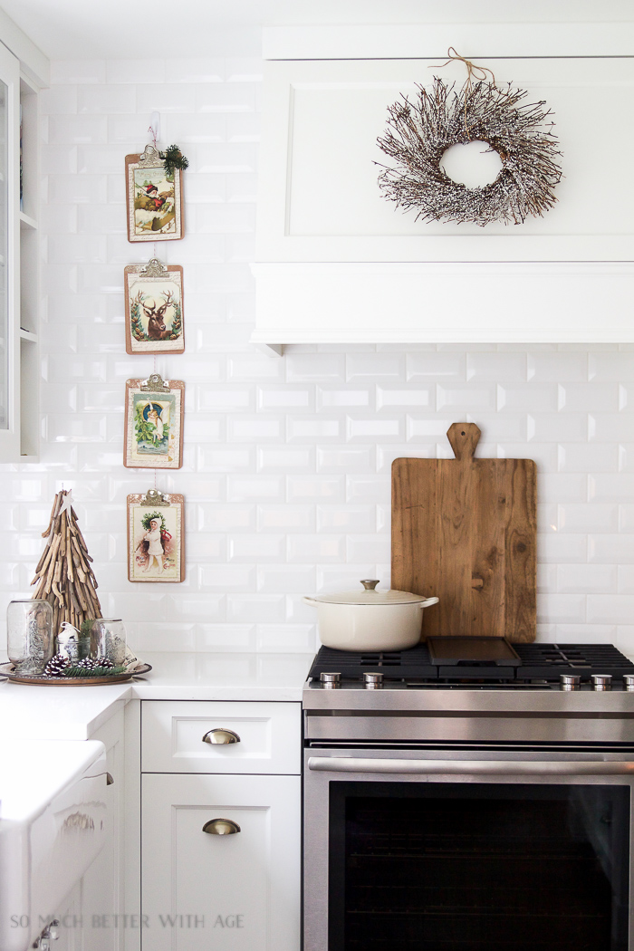  White subway tile and wreath is on the range hood.