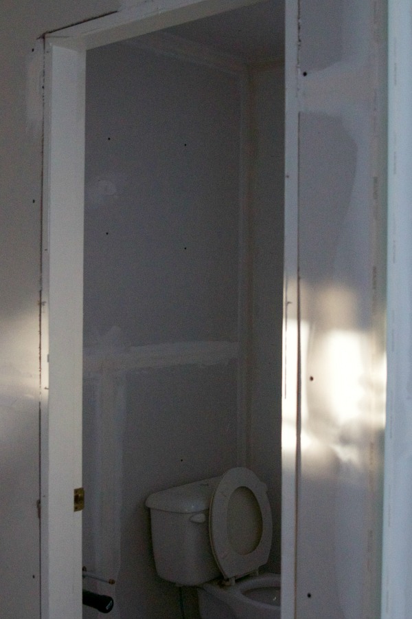 The bathroom with a toilet installed.