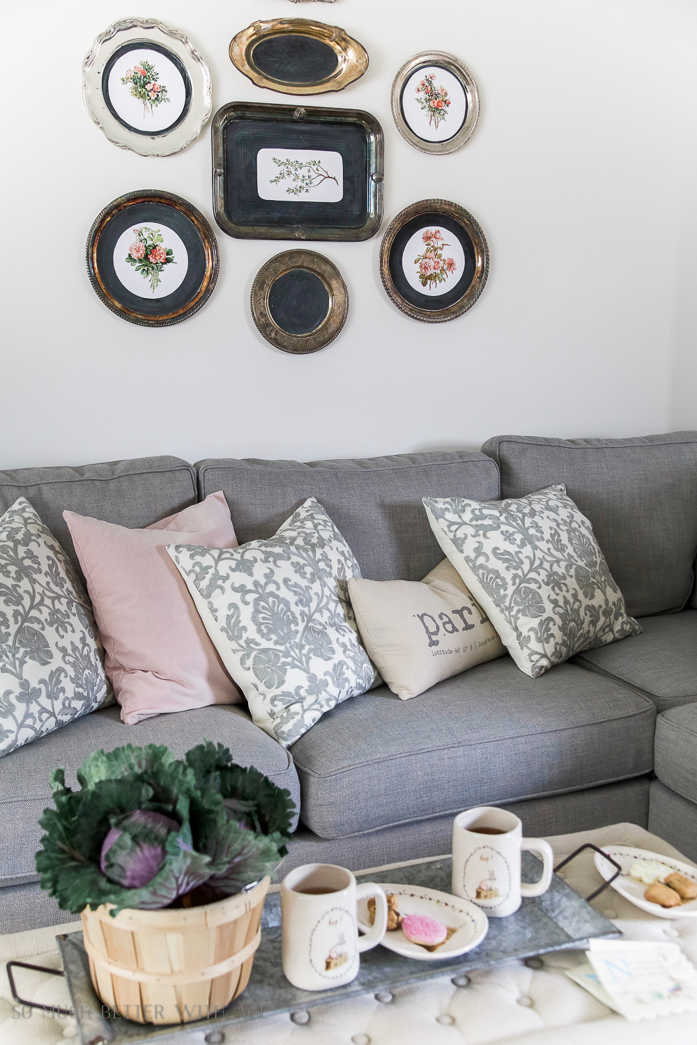 Florals in silver trays on the wall.