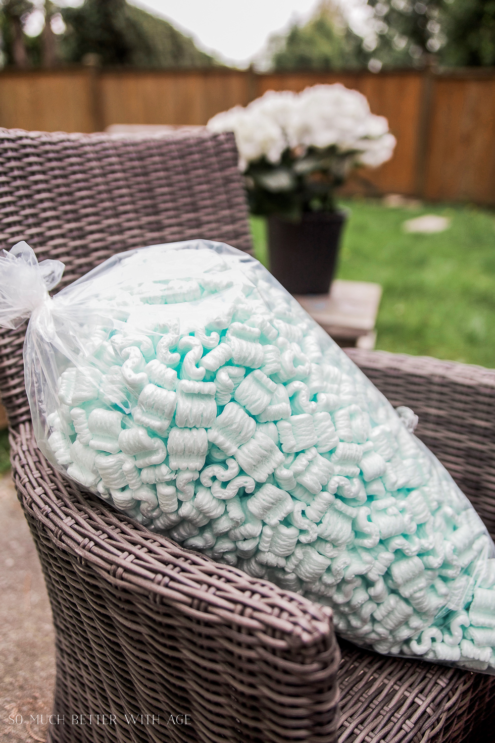 Wicker chair outside with back of styrofoam on it.