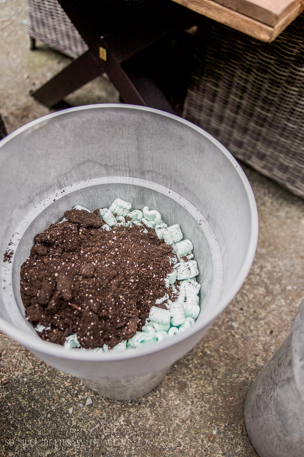 Packing the soil down into the planter.